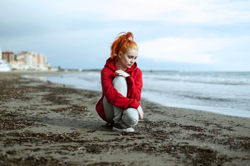 Young woman sad at the beach