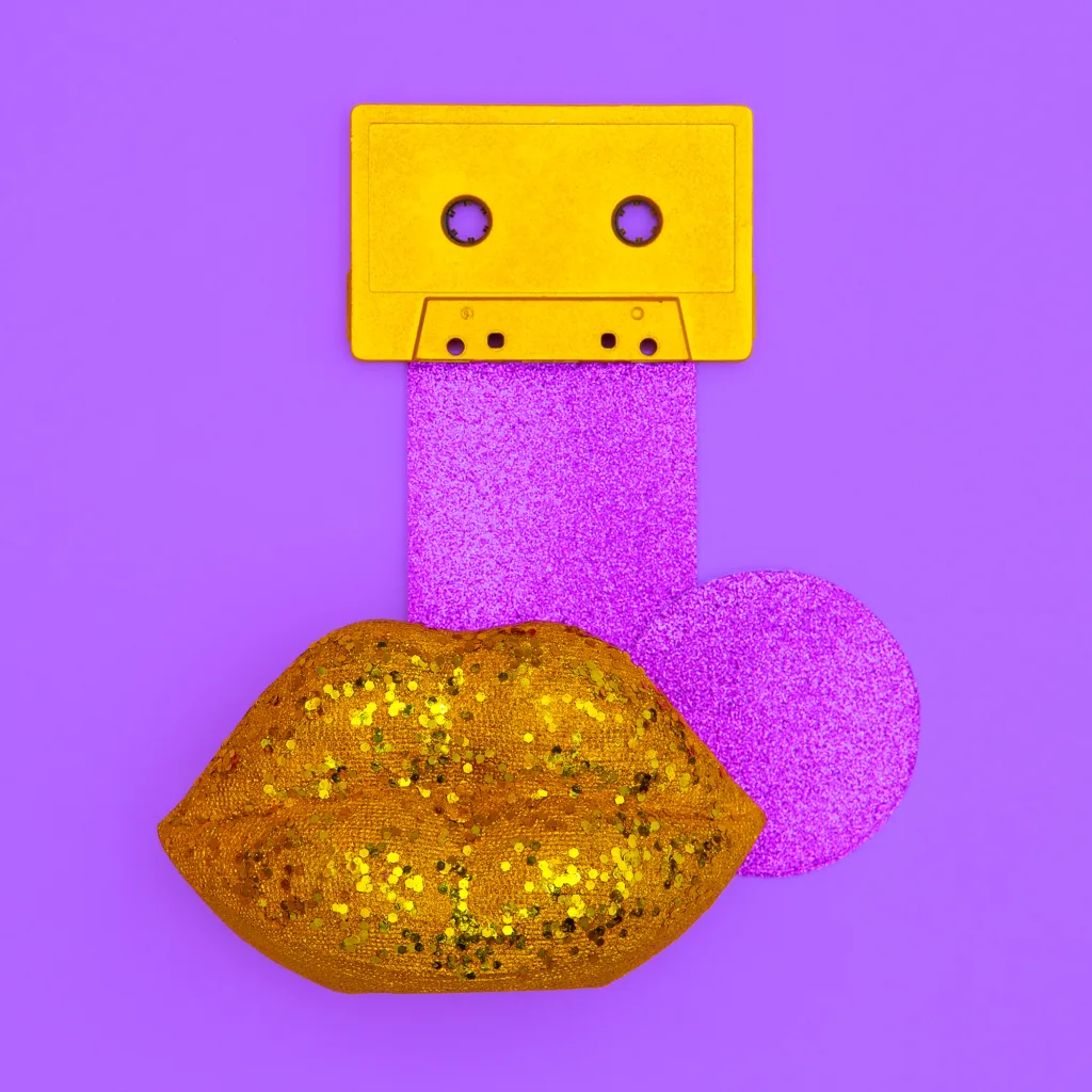 Lips and audio cassette. Minimal music flat lay art