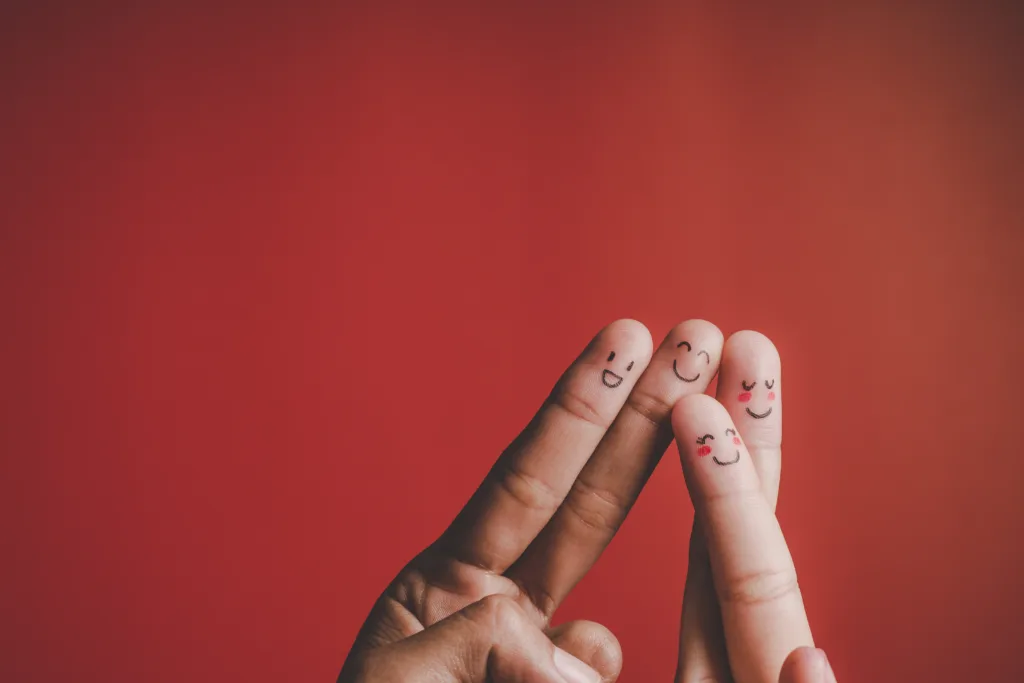 Fingers with emotion on red background