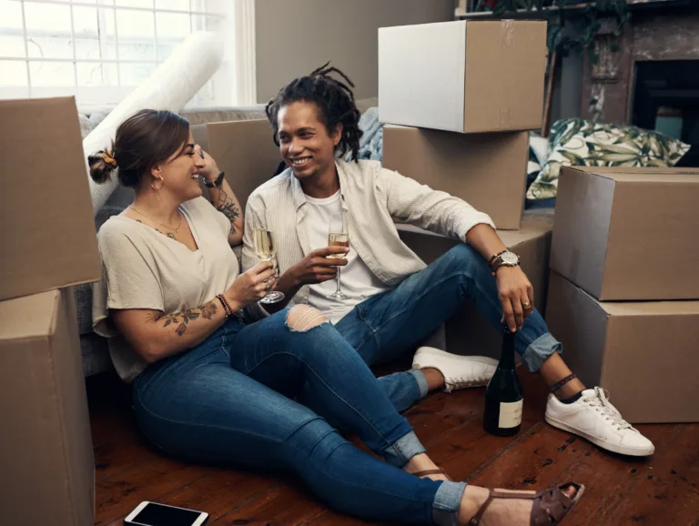 happy young couple having champagne to celebrate their new home.